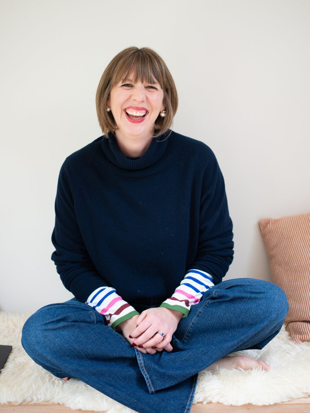 Sophie Griffiths laughing, sitting on a cushion